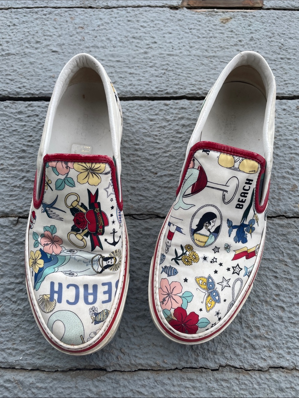 Gucci White Slip-On Sneakers with Red Trim and Multicolor Beach Print